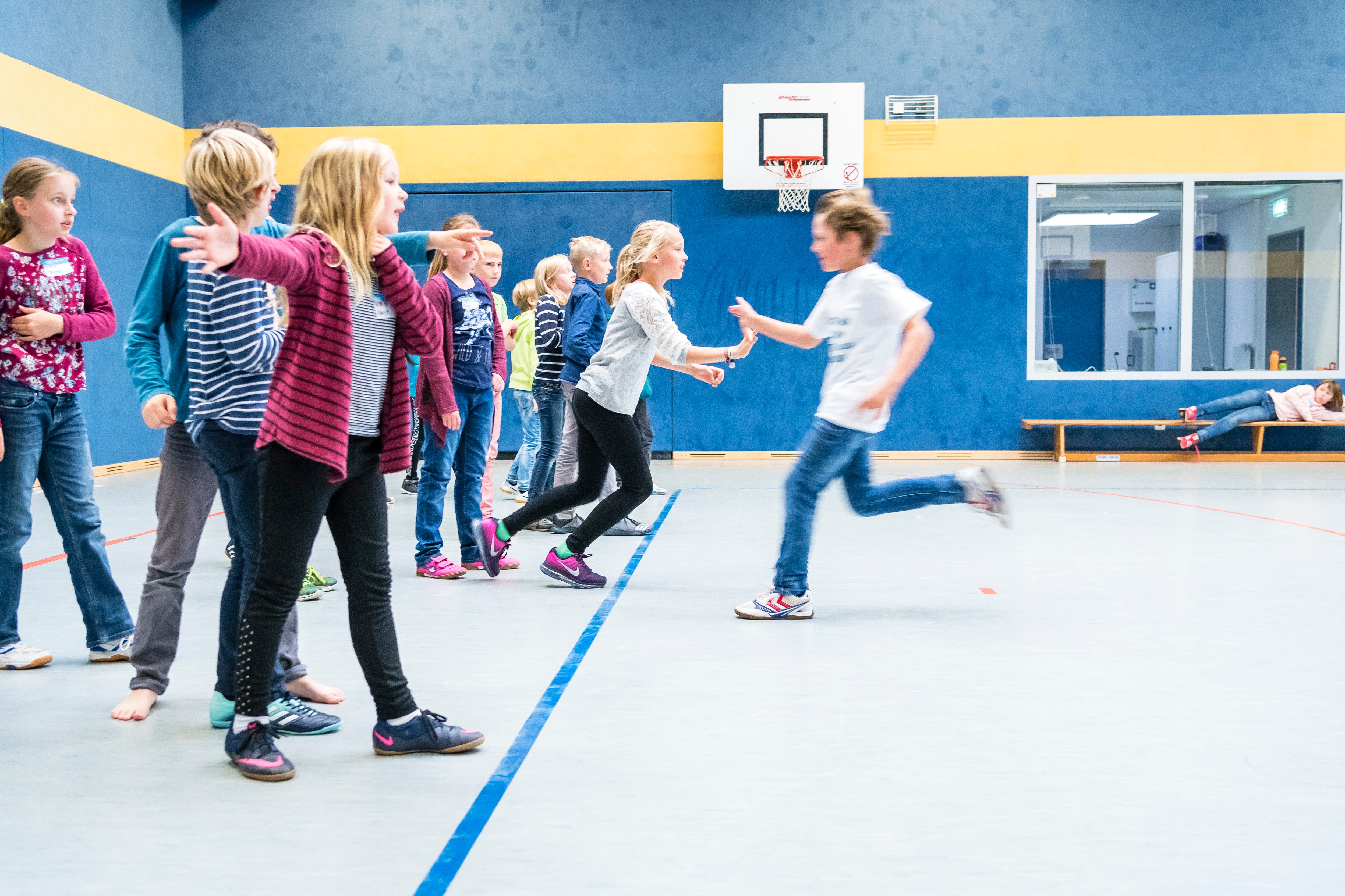 Kinder spielen am Projekttag "Mehr bewegen - besser essen" der EDEKA Stiftung ein Bewegungsspiel in der Turnhalle.